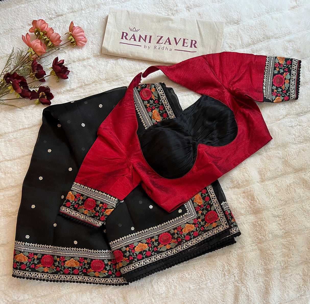 Designer blouse paired with black pure organza saree